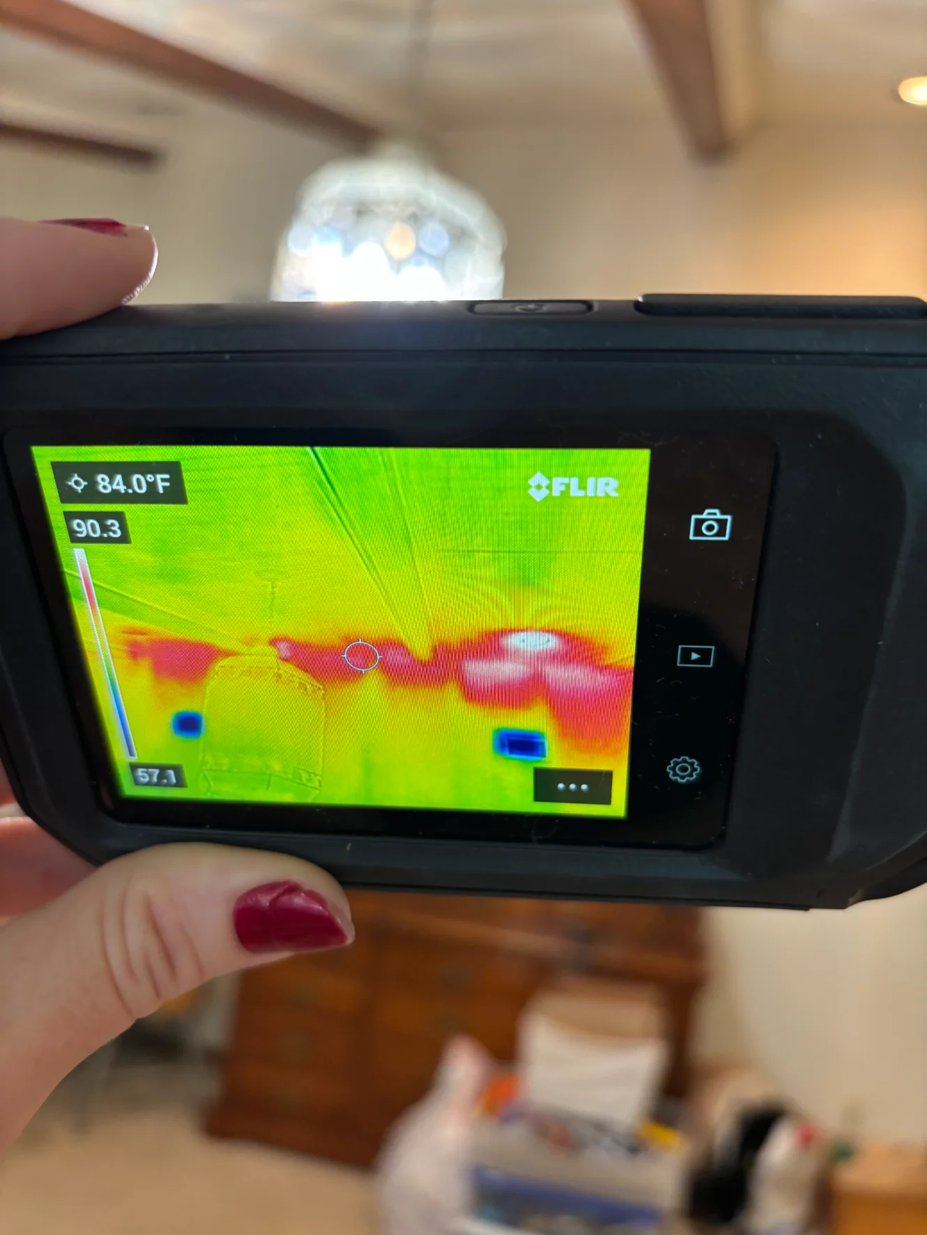 Thermal imaging camera detecting moisture behind walls